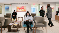 A patient sits in a waiting room waiting for her dermatologist
